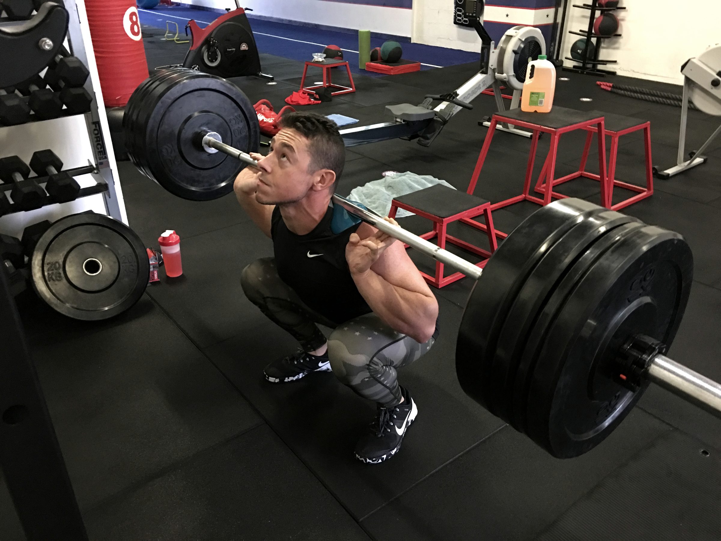 Damian Quinton mid-squat under a heavy barbell
